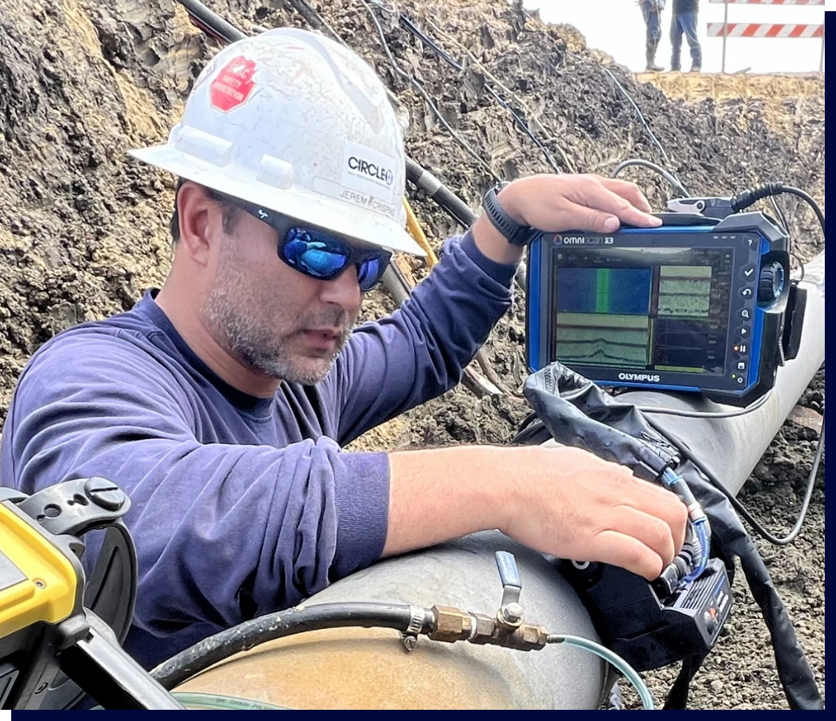 Technician inspecting pipeline with equipment