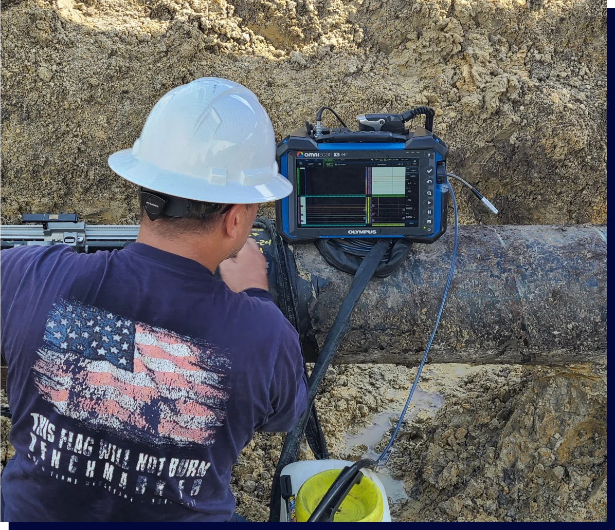 Technician using device on large pipeline
